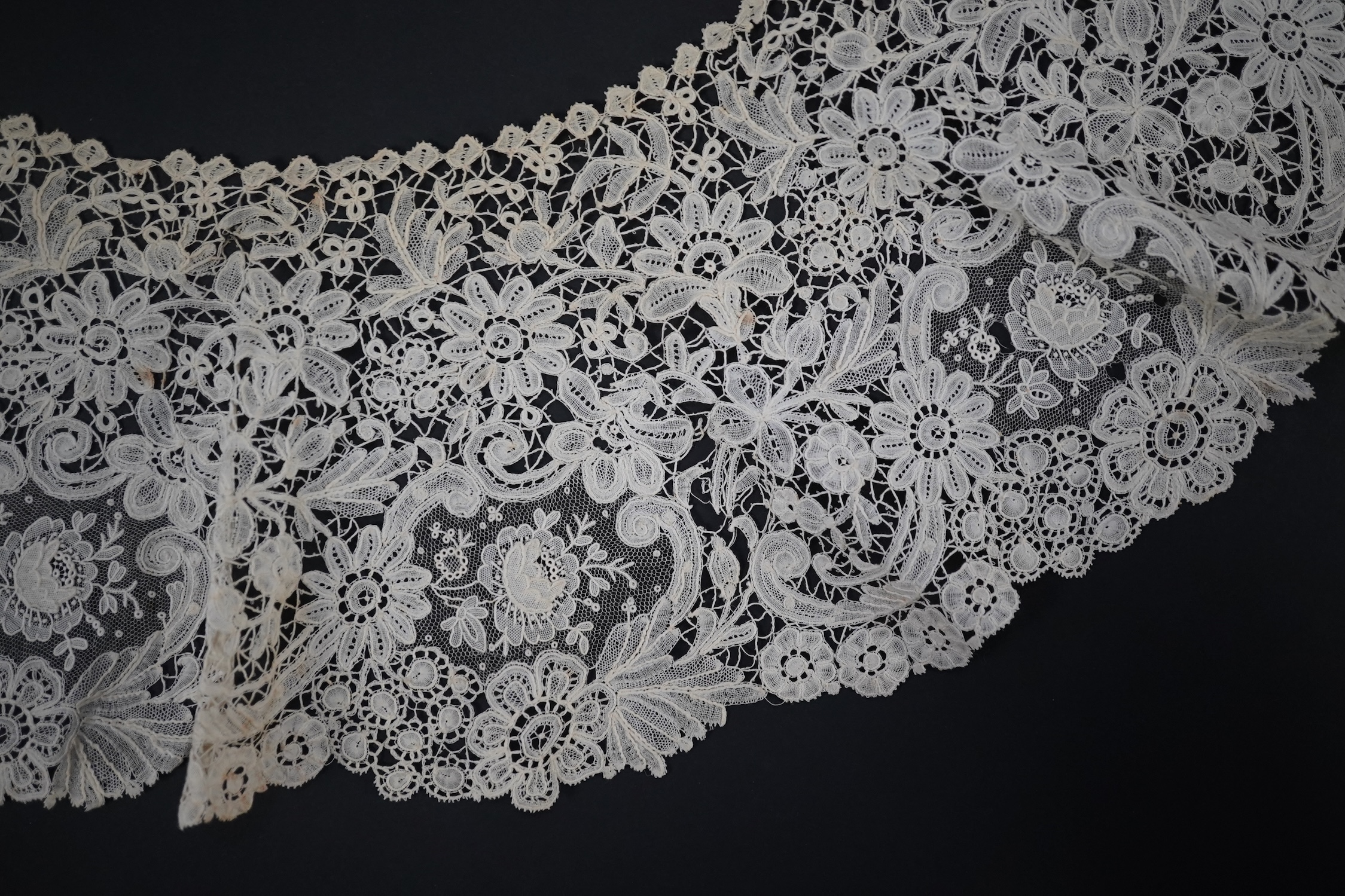 An 1860’s unused, large circular flounce shaped collar of mixed Brussels bobbin lace, with twelve needle lace Point de Gaz insertions, 18.5cm deep, approximately 248cm along bottom, edge. Condition - good